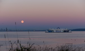 Moonrise over Vancouver with ferry in foreground, seen from Seymour Shores